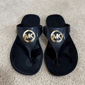 Michael Kors Black Flip Flops with Gold Emblem